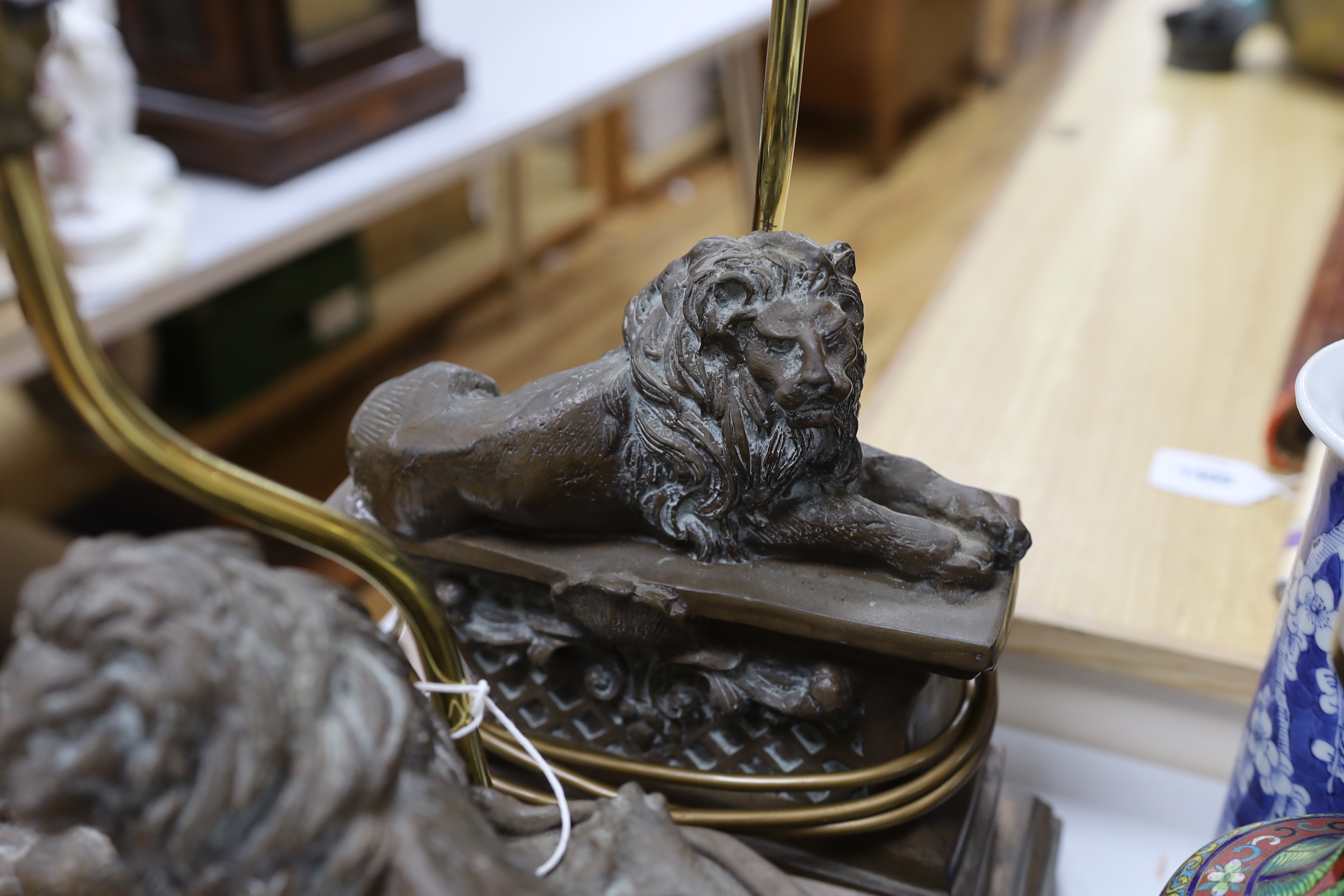 A pair of Thomas Blakemore recumbent lion table lamps, 43cm tall